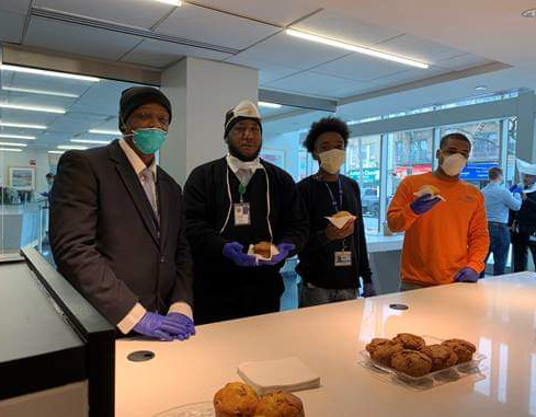 Four men with pastries