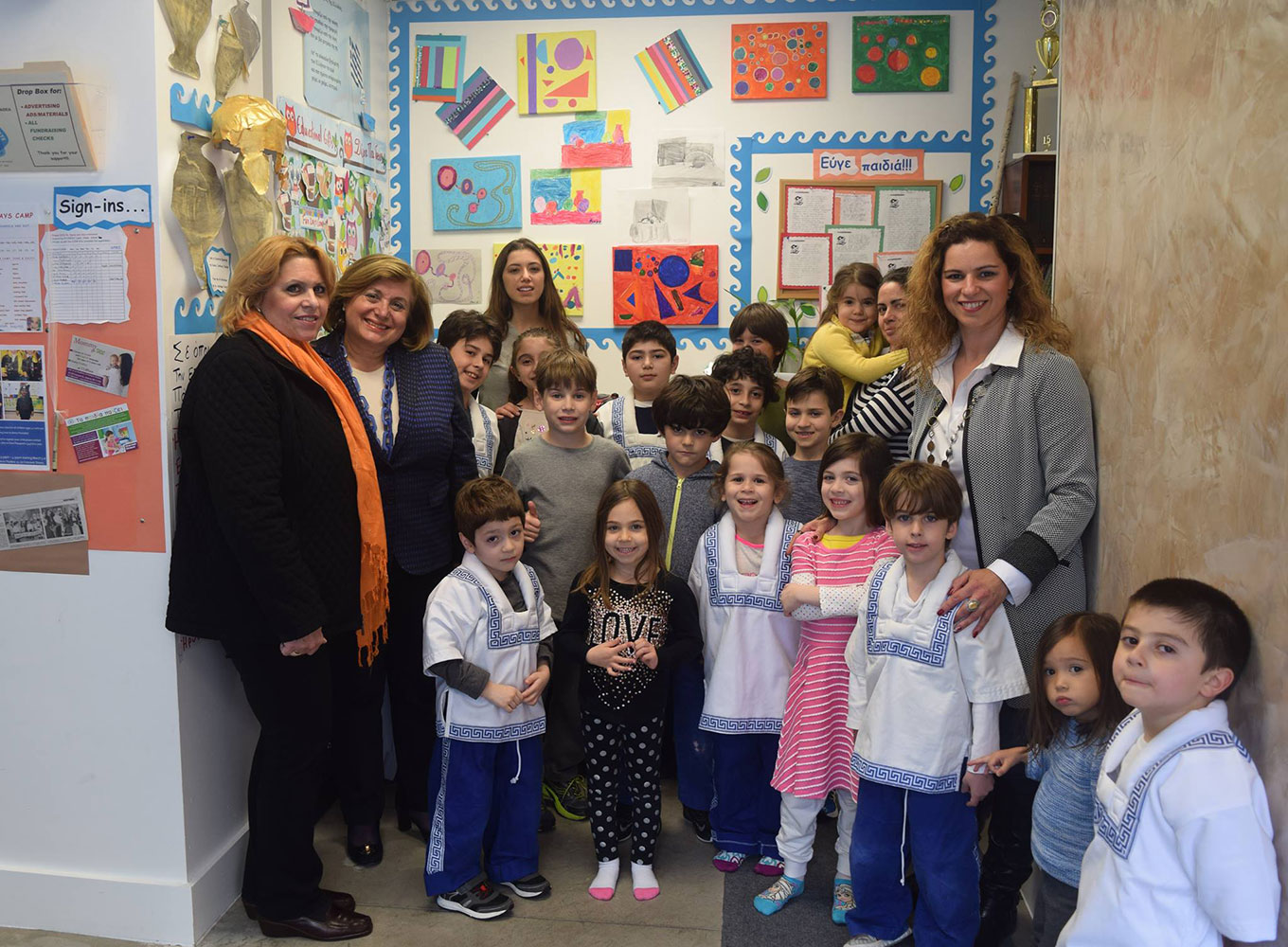 Adults and Children standing in a classroom